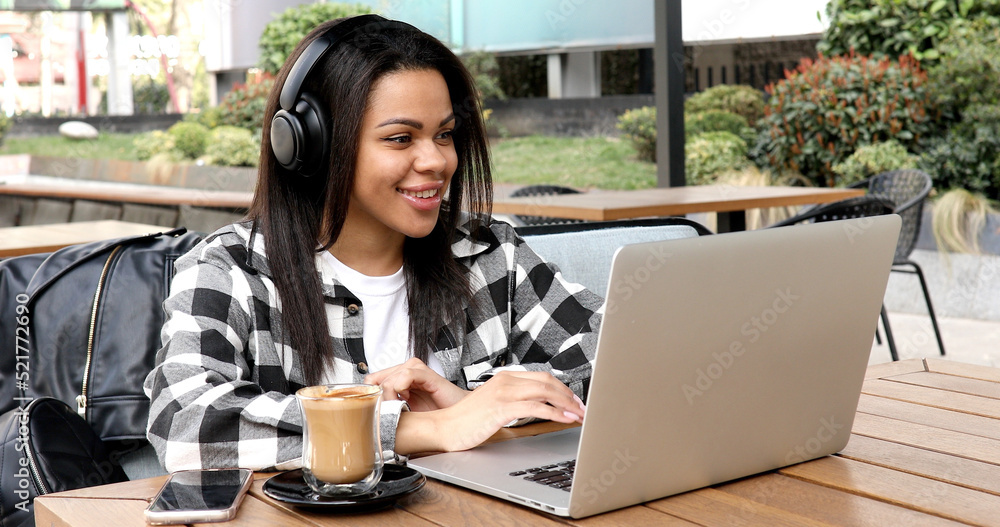 Photo portrait of gorgeous attractive woman working on laptop typing sitting in cafe drinking coffee Photo portrait of gorgeous attractive woman working on laptop typing sitting in cafe drinking coffee