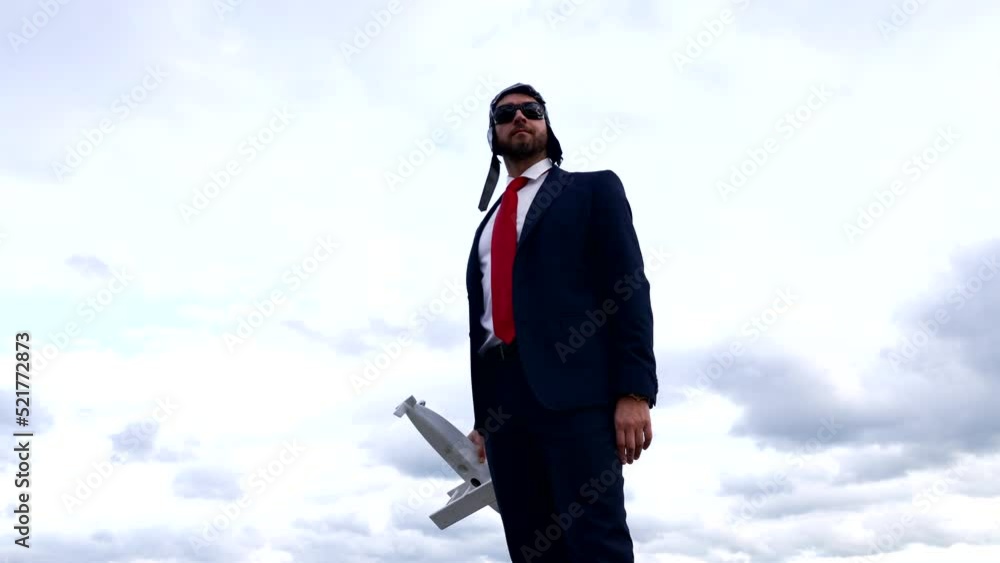 man in business suit and pilot hat with glasses hold plane, success man in business suit and pilot hat with glasses hold plane, success