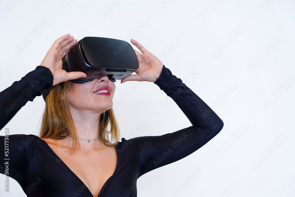 Woman with virtual reality glasses on white background, futuristic concept, metaverse, smiling holding the glasses Woman with virtual reality glasses on white background, futuristic concept, metaverse, smiling holding the glasses