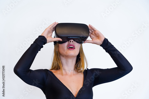 Woman wearing virtual reality goggles on white background, futuristic concept, metaverse, shocked