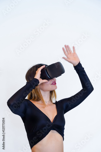 Woman wearing virtual reality goggles on white background, futuristic concept, metaverse, vertical photo
