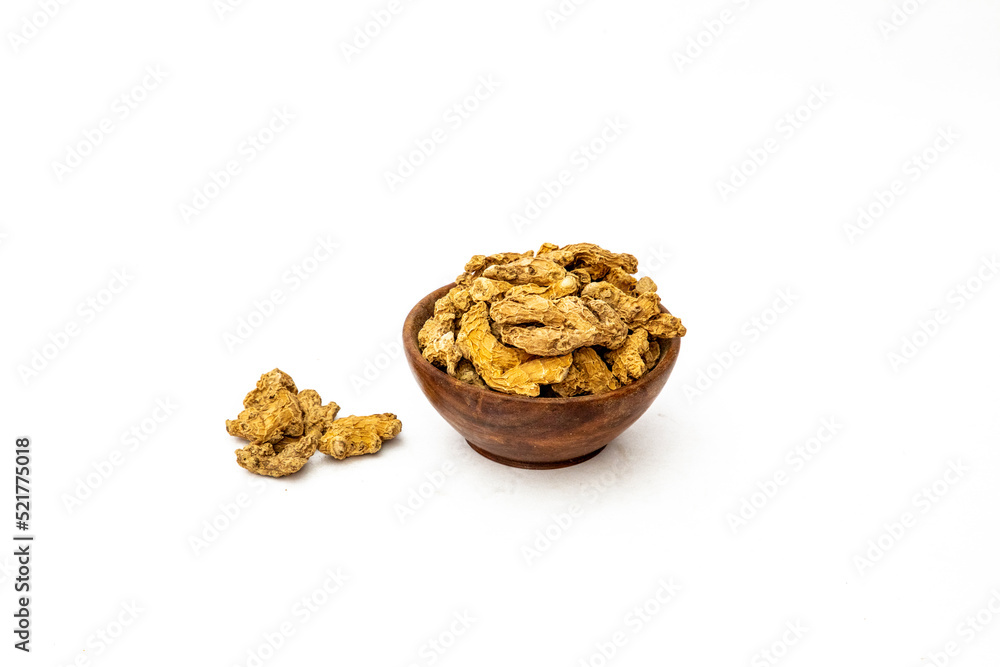 Dry ginger slices or zingiber officinale in bowl isolated on white background Dry ginger slices or zingiber officinale in bowl isolated on white background