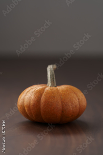 Cute orange pumpkin on wood table with copy space
