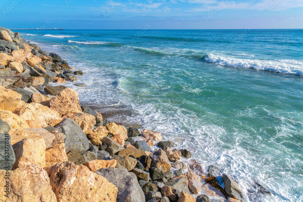 Waves crashing on the seawall with large rocks in San Clemente, California Waves crashing on the seawall with large rocks in San Clemente, California
