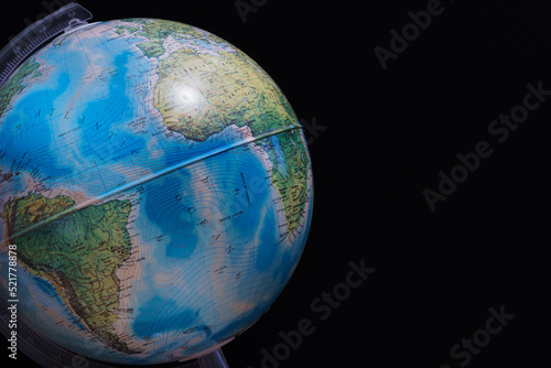Φωτογραφία World globe set against a dark black board background