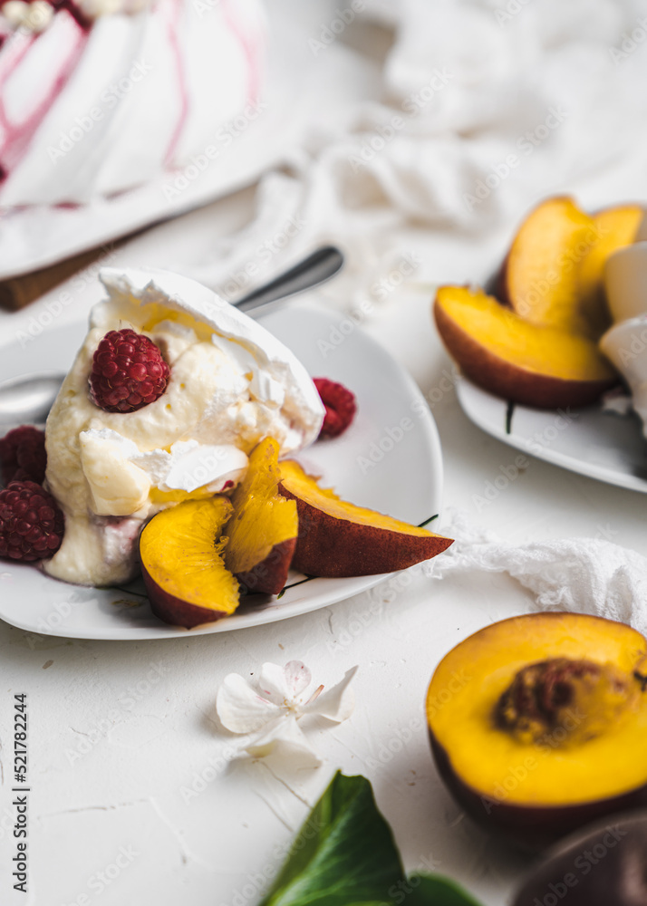 sweet dessert Pavlova cake with raspberries and cream peach