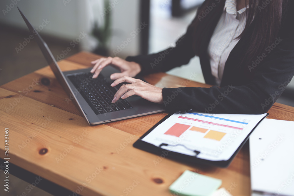 Businesswomen use computers to analyze work Businesswomen use computers to analyze work