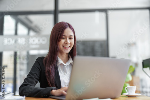 Portrait of a business woman using a computer to work on financial statements