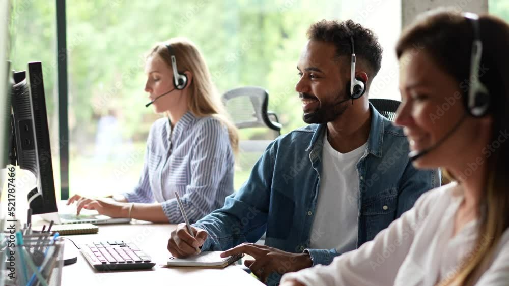 Male representative call center agent in wireless headset helping client, operator working in customer support service