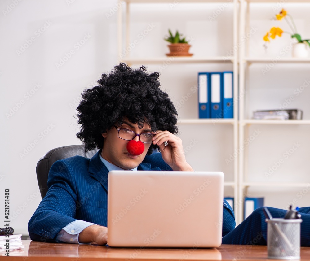 Young clown businessman working in the office Young clown businessman working in the office