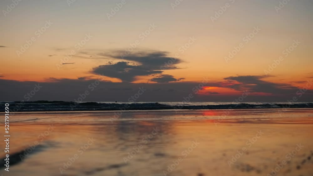 Beautiful sunset on the mediterranean sea on a sandy beach. Dramatic sea view. Burning sky and shining golden waves. Background for weather forecast and weekend