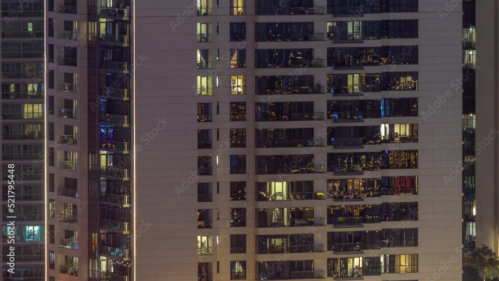Windows illuminated at night in modern residential buildings timelapse. Multi-level skyscrapers with many glowing lights. Windows illuminated at night in modern residential buildings timelapse. Multi-level skyscrapers with many glowing lights.