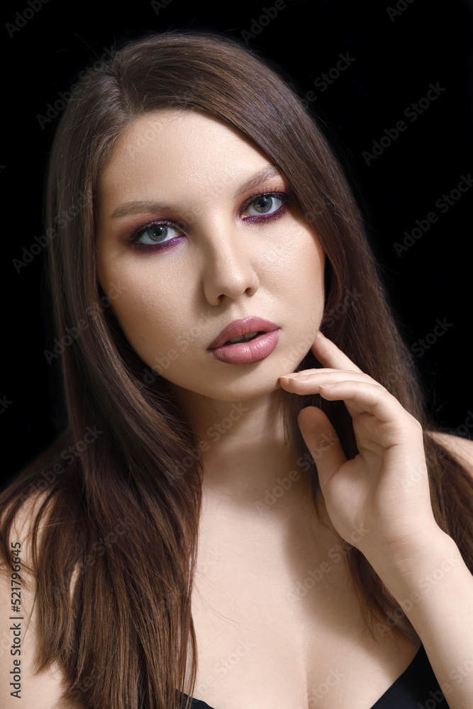 vertical beauty portrait of a brunette woman on a black background. vertical beauty portrait of a brunette woman on a black background.