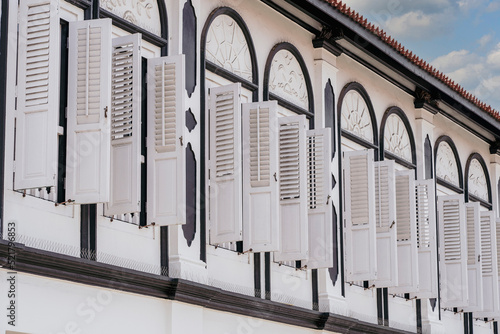 Canvas Print Window with white wooden shutters on wall building, Singapore
