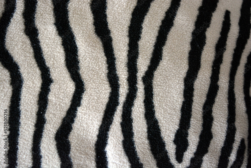 Soft, pleasant, fluffy fabric in the form of zebra, white tiger colors. Fabric animal background consisting of black and white chaotic lines, stripes, cracks. Soft, pleasant, fluffy fabric in the form of zebra, white tiger colors. Fabric animal background consisting of black and white chaotic lines, stripes, cracks.