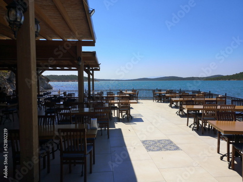 Terrasse eines Restaurant mit Panoramablick im Sommer vor blauem Himmel im Sonnenschein am Strand von Ayvalik in der Provinz Balikesir am Ägäischen Meer in der Türkei photo