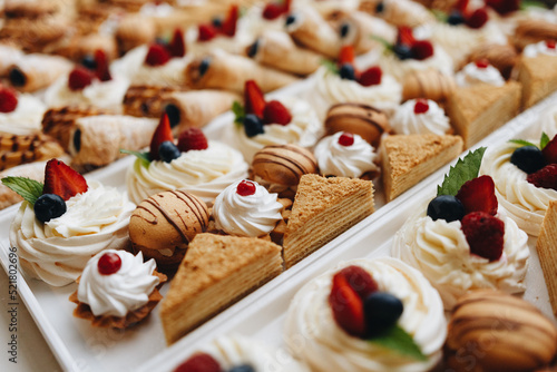 Beautifully decorated catering banquet table with different food snacks and appetizers