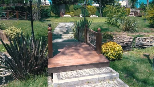 Walking footage of the park in Emirgan Korusu (Emirgan Grove) in Istanbul Turkey with flowers, wooden small bridge and trees in summer photo