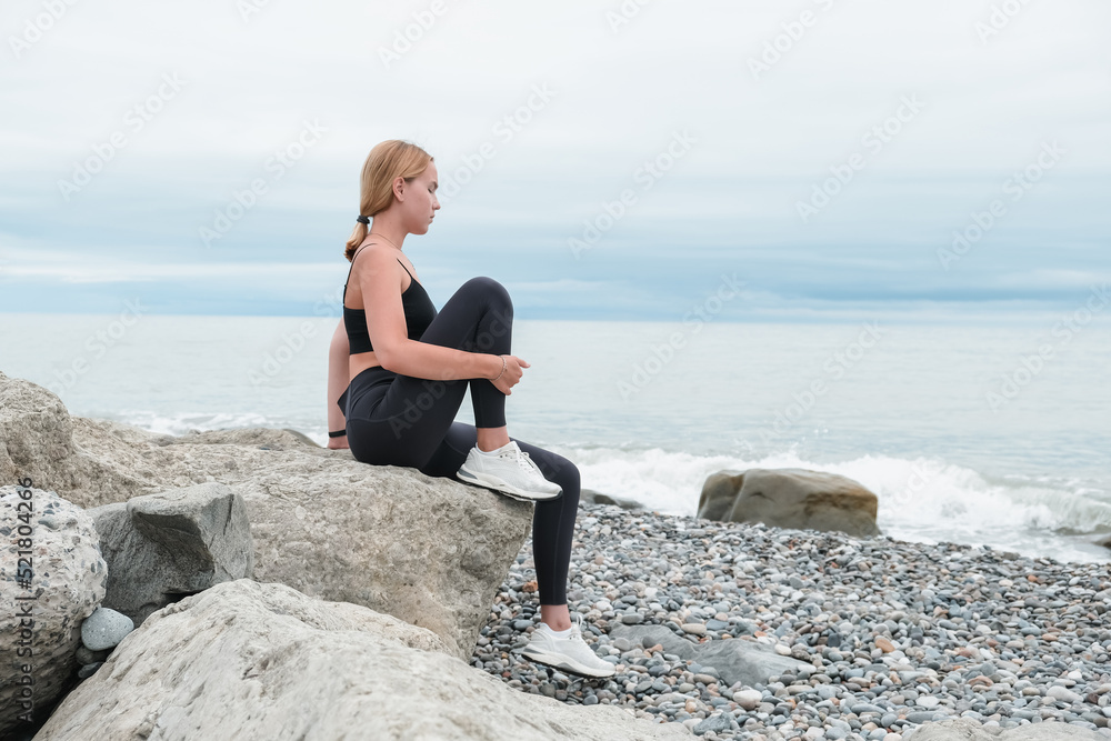 sport fit outdoor sea.girl goes sports,fitness,yoga seashore.Meditation, relaxation, mental health.Active lifestyle, self-care, health.Wellness.Fit nature.myofascial release workouts tracking fitness