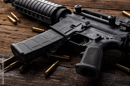 Gun with ammunition on table background. 