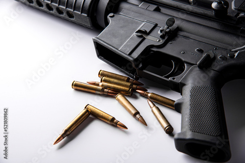 Gun with ammunition on table background. 
