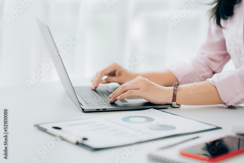 Business woman sitting using laptop computer with on the desk in the office