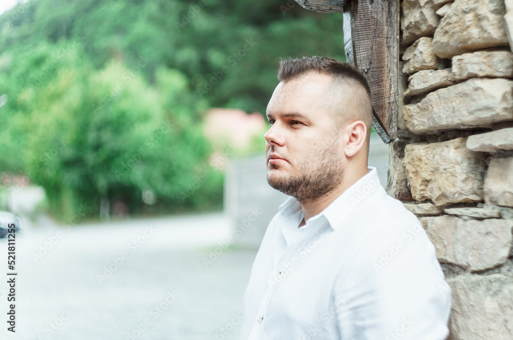 Young bearded man, model of fashion, in urban background Young bearded man, model of fashion, in urban background