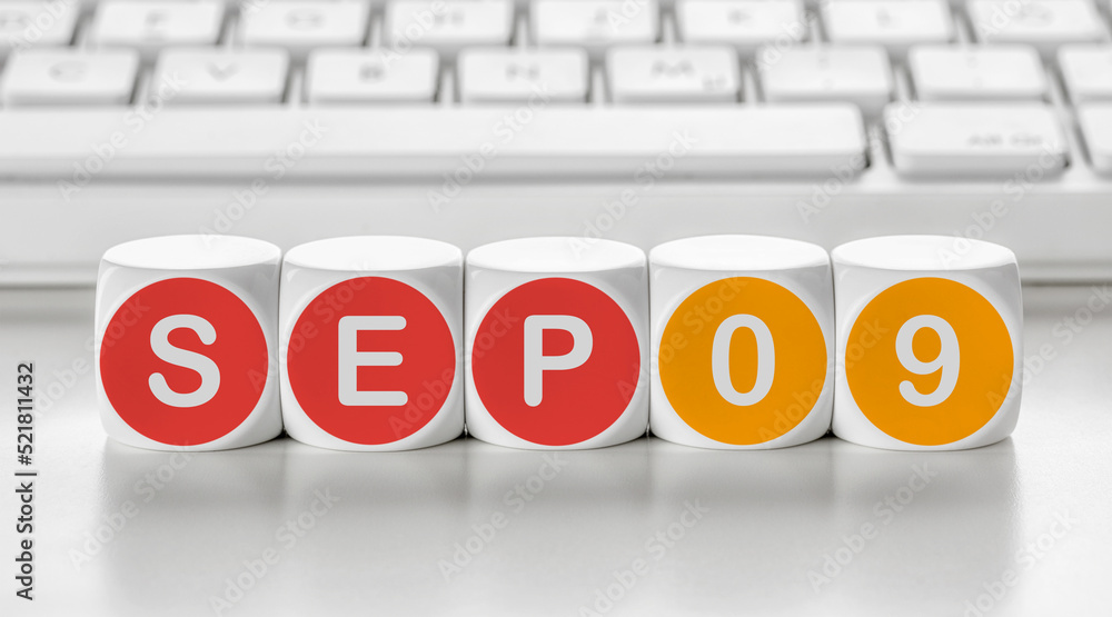 Letter dice in front of a keyboard - September 09