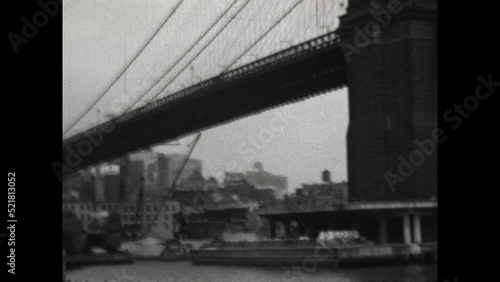 Brooklyn Bridge 1931 - Viewing the Brooklyn Bridge from a ferry that passes beneath it in New York, New York, 1931.  photo