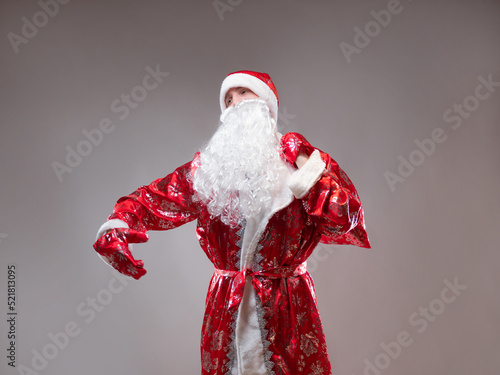 Canvas Print Santa Claus is a traditional Russian grandfather in a red caftan with a bag of gifts