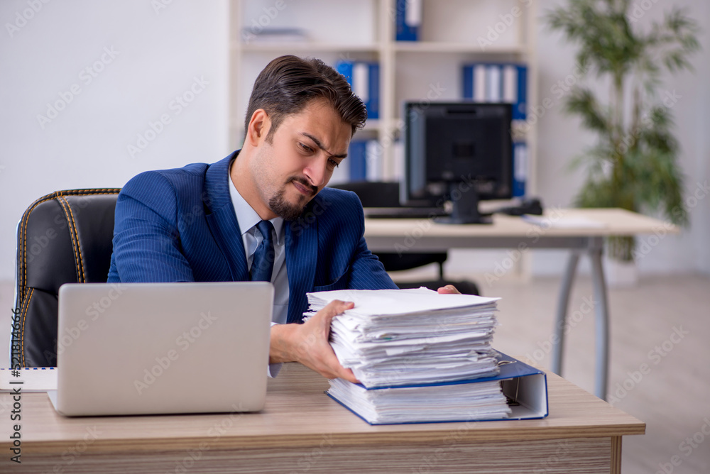 Young male employee working in the office Young male employee working in the office