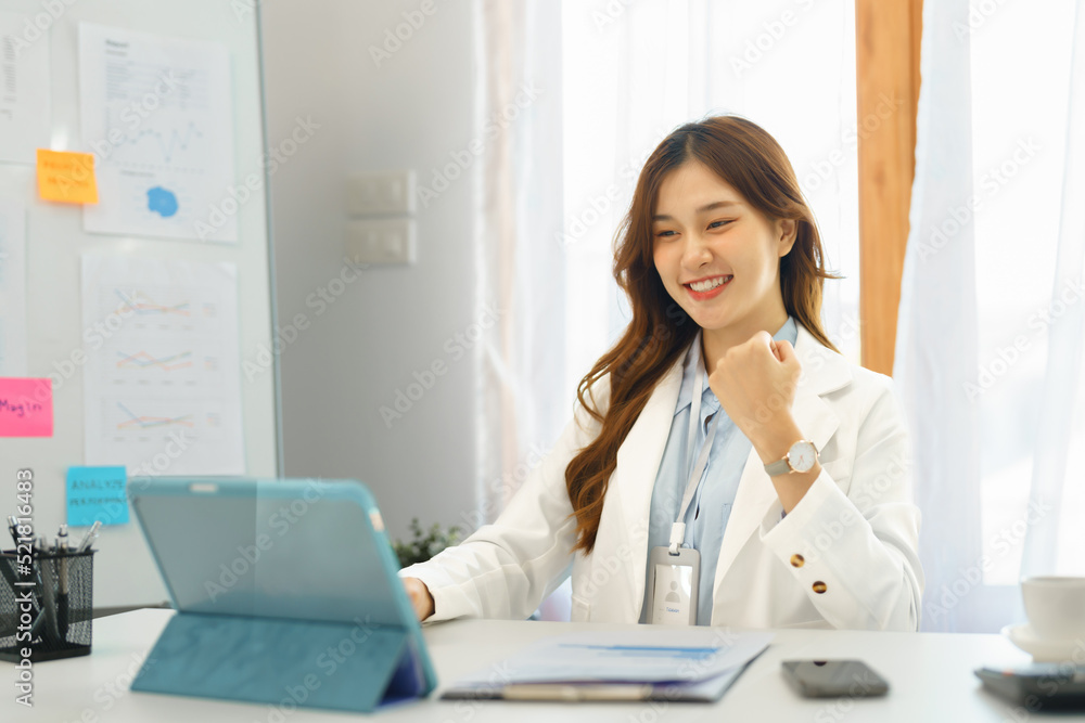 Successful business concept, Businesswoman raising fist to celebrate when finished new project Successful business concept, Businesswoman raising fist to celebrate when finished new project
