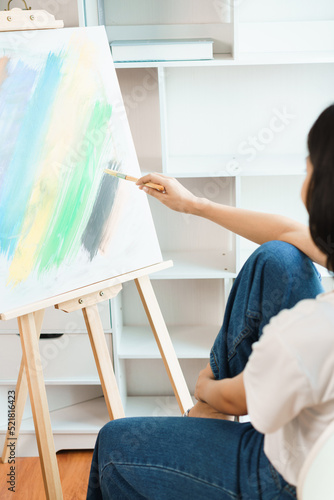 The art concept, Asian female artist using paint brush to painting for create artwork on canvas