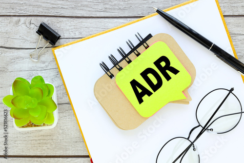 ADR - financial conceptbeautiful layout for your text. text on creative notepad photo