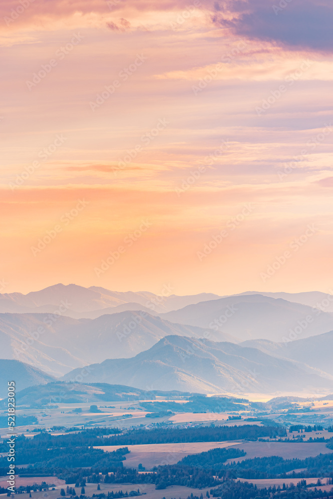 Beautiful nature landscape, sunset foggy sunlight over the mountains. Serenity mist light, abstract scenic. Europe mountains, colorful layers, silhouette of mountains during sunset amazing view
