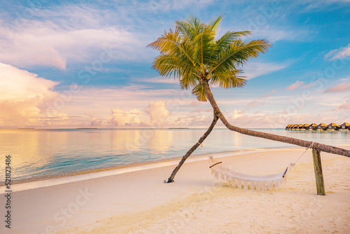 Fototapeta Naklejka Na Ścianę i Meble -  Relax vacation leisure lifestyle on exotic tropical island beach, palm tree hammock hanging calm sea. Paradise beach landscape, water villas, sunrise sky clouds amazing reflections. Beautiful nature