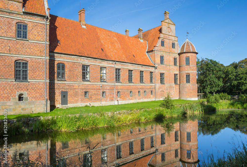 Historic castle reflected in the water in Rosenholm
