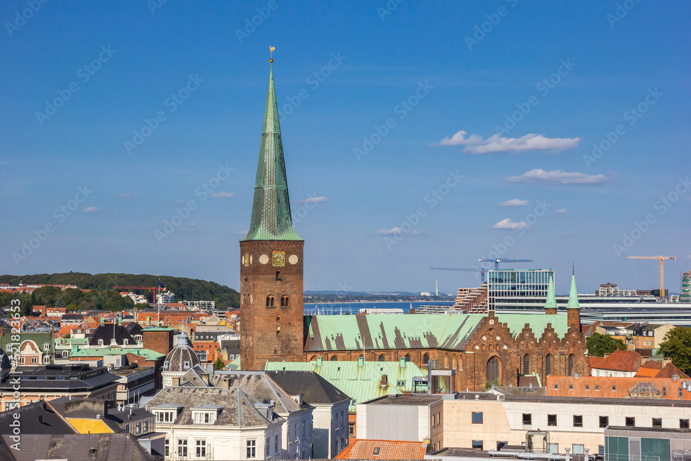 Tower of the historic Domkirke church in the skyline of Aarhus
