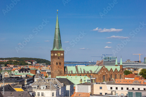 Tower of the historic Domkirke church in the skyline of Aarhus