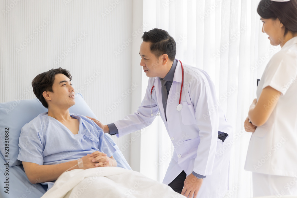 Professional male doctor and nurse caring visiting encourage male patient at hospital Professional male doctor and nurse caring visiting encourage male patient at hospital