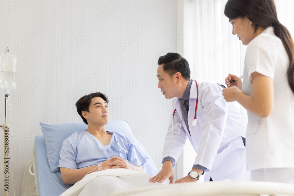 Professional orthopaedist male doctor and nurse visiting checking examine knee condition male patient at hospital Professional orthopaedist male doctor and nurse visiting checking examine knee condition male patient at hospital