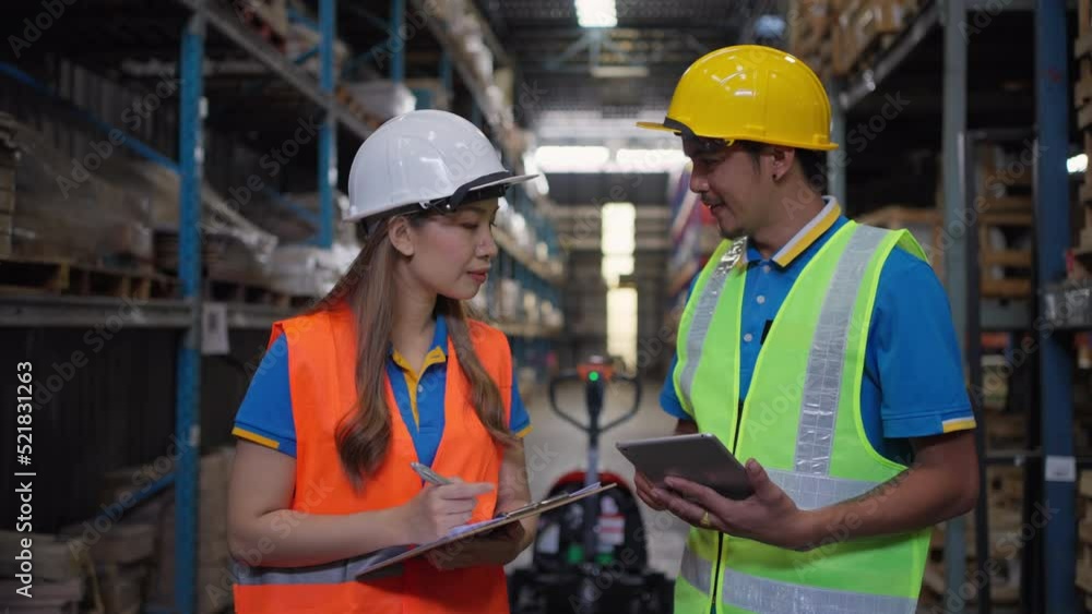 Two male and female warehouse staff working together to check the inventory at their company warehouse site Two male and female warehouse staff working together to check the inventory at their company warehouse site