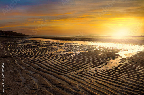 Colorful sunset on the Atlantic coast at low tide in Normandy  France