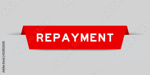 Red color inserted label with word repayment on gray background