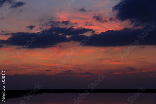 Sunset on the calm water of tha saline