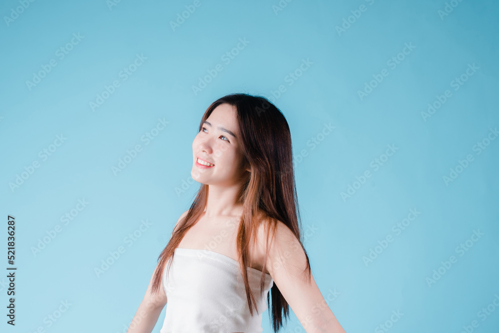 Charming portrait of Asian woman smiling confidence beauty make up on the blue background Charming portrait of Asian woman smiling confidence beauty make up on the blue background