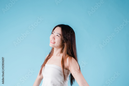 Charming portrait of Asian woman smiling confidence beauty make up on the blue background