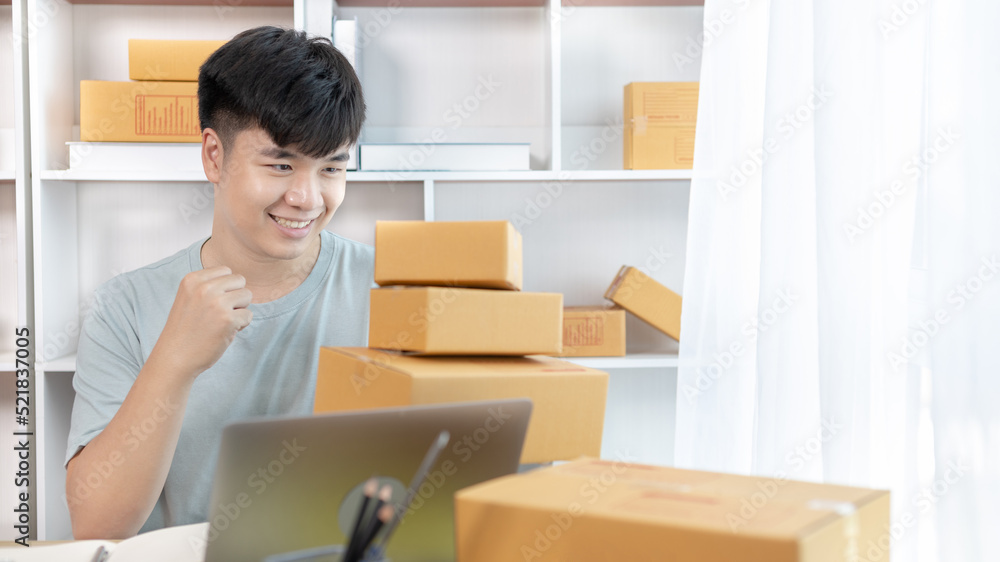 Man was happy after receiving an order from an internet customer, New business style for young people working at home and owning businesses, Online shopping SME entrepreneur, Packing box, Sell online. Man was happy after receiving an order from an internet customer, New business style for young people working at home and owning businesses, Online shopping SME entrepreneur, Packing box, Sell online.