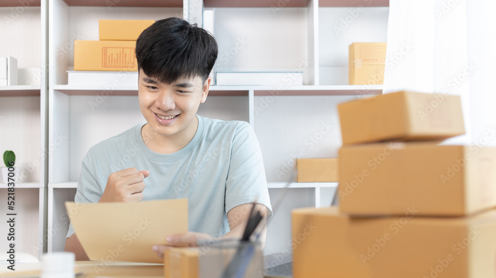 Man was happy after receiving an order from an internet customer, New business style for young people working at home and owning businesses, Online shopping SME entrepreneur, Packing box, Sell online. Man was happy after receiving an order from an internet customer, New business style for young people working at home and owning businesses, Online shopping SME entrepreneur, Packing box, Sell online.