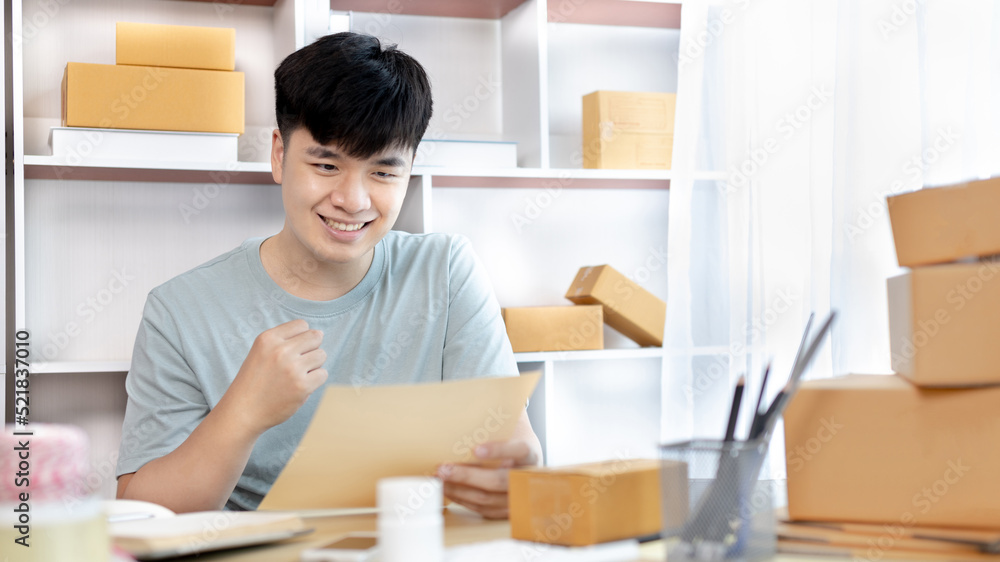 Man was happy after receiving an order from an internet customer, New business style for young people working at home and owning businesses, Online shopping SME entrepreneur, Packing box, Sell online. Man was happy after receiving an order from an internet customer, New business style for young people working at home and owning businesses, Online shopping SME entrepreneur, Packing box, Sell online.